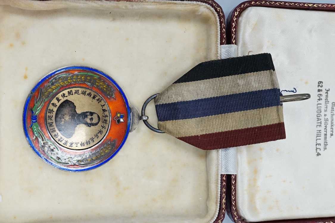 A Chinese Wu Pei Fu Sharpshooter enamelled medal, c.1915, with portrait of Wu Pei Fu to the obverse and crossed foliated rifles to the reverse, 40cm diameter
